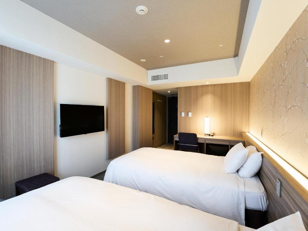 Postel nebo postele na pokoji v ubytování Hotel Elcient Kyoto Hachijoguchi