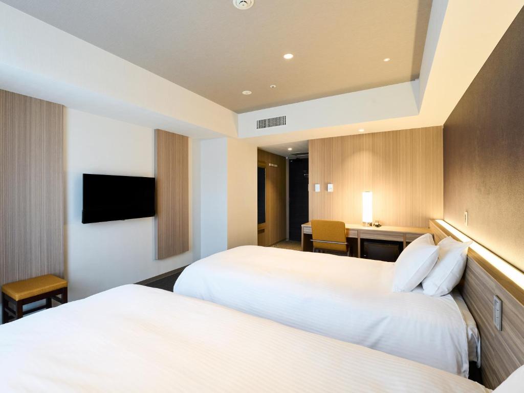 Postel nebo postele na pokoji v ubytování Hotel Elcient Kyoto Hachijoguchi