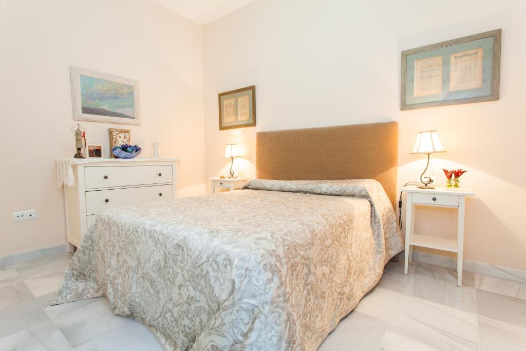 a bedroom with a bed and two night stands at Casa Singular , parking gratis in Jerez de la Frontera