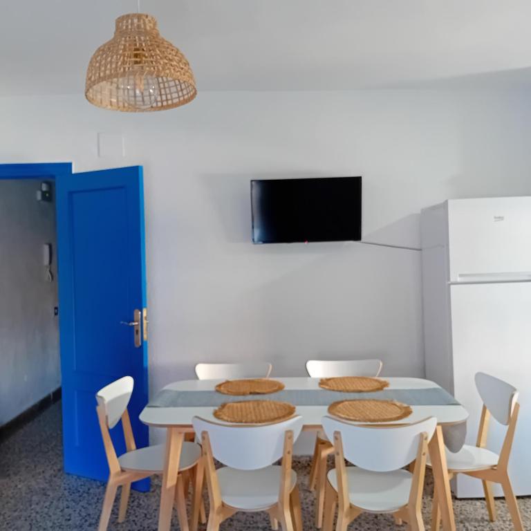 a dining room with a blue table and chairs at María PLAYA ARENA NG in Peniscola