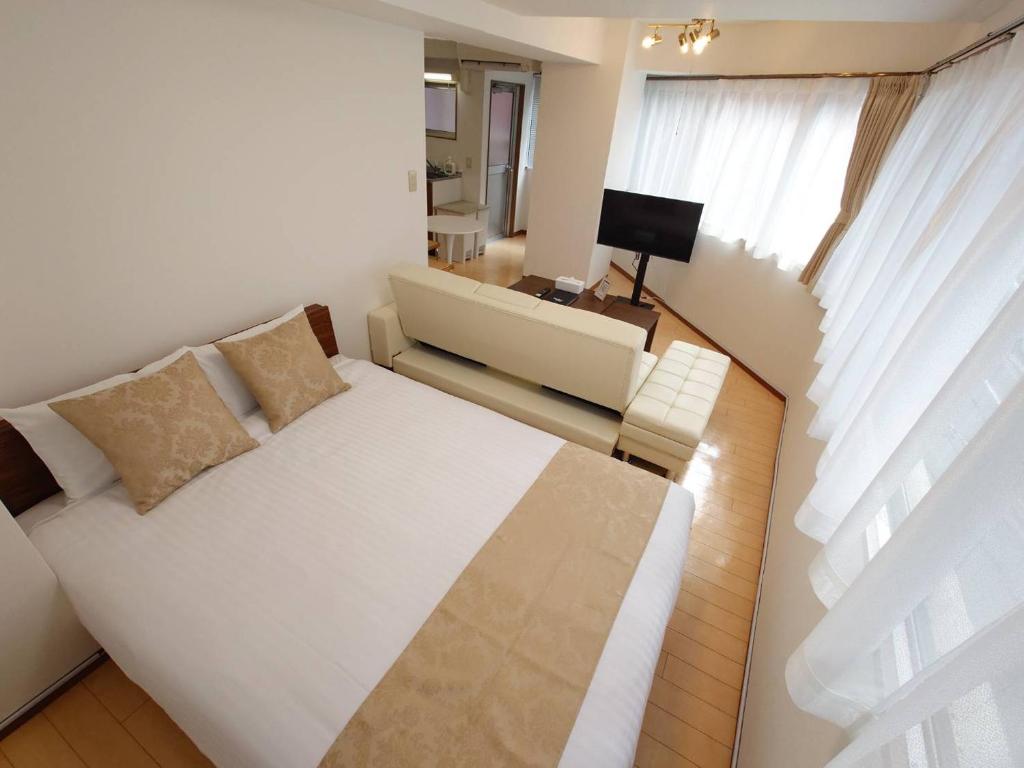 Postel nebo postele na pokoji v ubytování Neighbor's Hotel 十日市