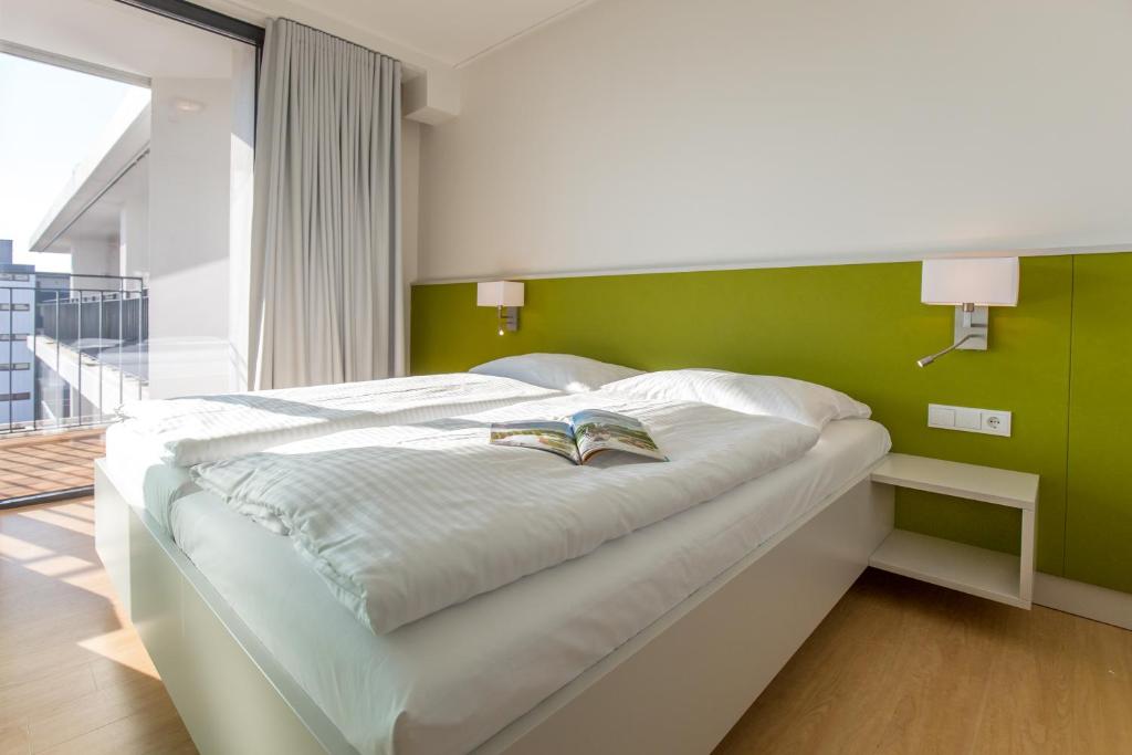 Postel nebo postele na pokoji v ubytování Carat Apartments Grömitz