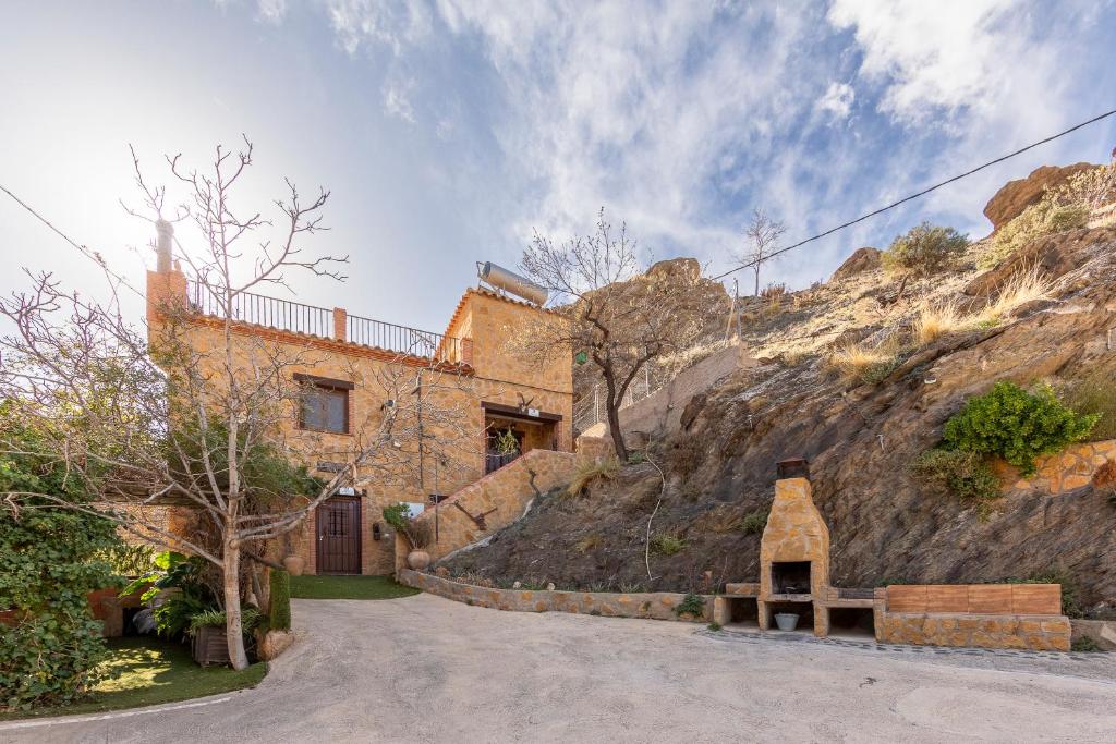 a house on the side of a mountain at Casa Rural La Jirola -Vivienda 2 in Escúllar