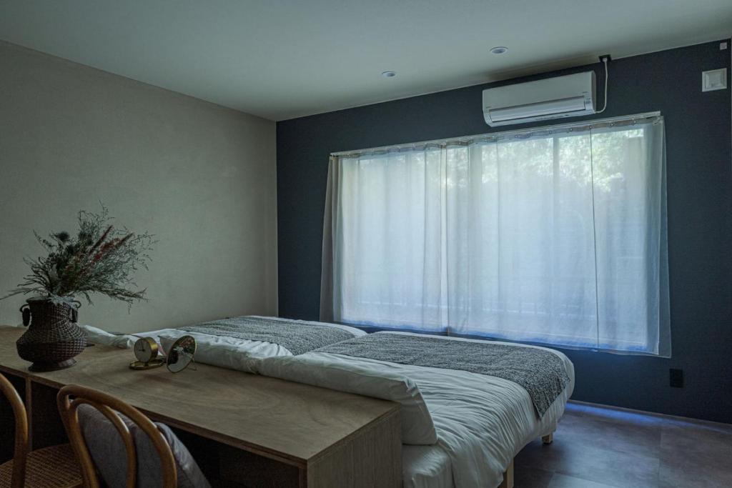 Postel nebo postele na pokoji v ubytování Nagasaki House Burabura