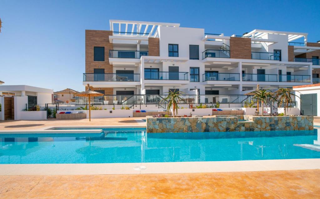 a swimming pool in front of a building at Apartment Laguna Azul in El Mojón