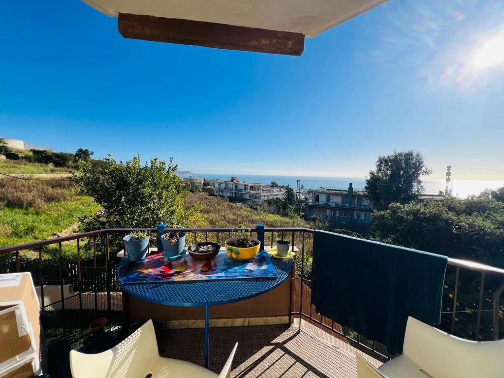 a table on a balcony with a view of the ocean at Suite Euforbia Bilo - Sanremo in Sanremo