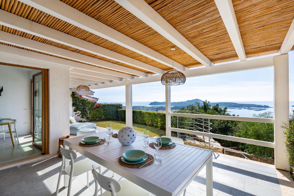 a dining room with a table and views of the ocean at Villa LUNA in Oasi dei Due Mari