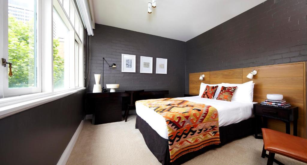 a bedroom with a bed and a window at Harbour Rocks Hotel Sydney – MGallery by Sofitel in Sydney