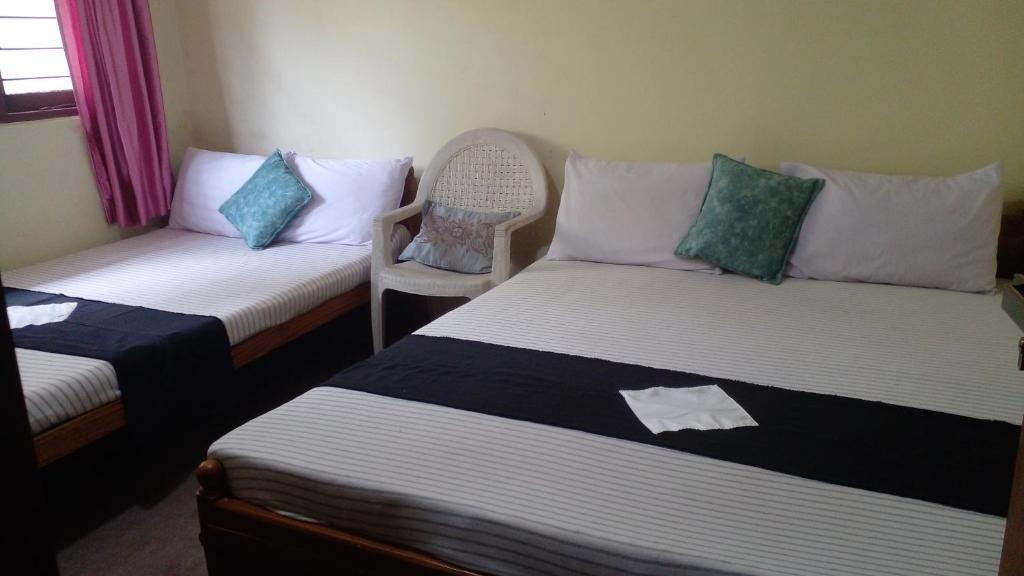 Postel nebo postele na pokoji v ubytování Haranya Homestay