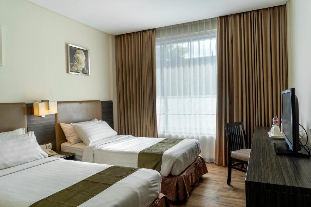 Ένα ή περισσότερα κρεβάτια σε δωμάτιο στο Estrella Hotel &amp; Conference