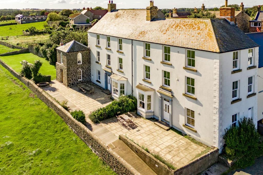 an aerial view of a large white house at No6 Sea Lane in Embleton