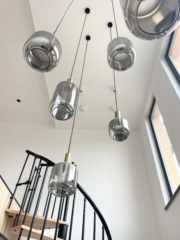 a bunch of glass lights hanging from a ceiling at Primaverii 10 by GIA in Caracal