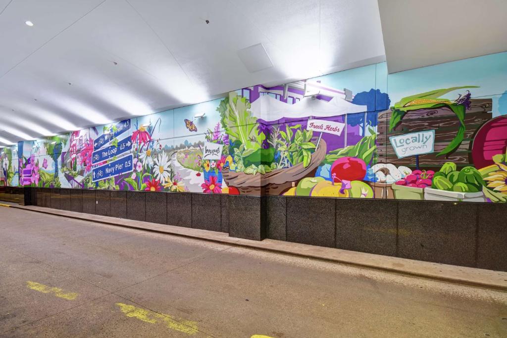 a wall with a mural of fruits and vegetables at Embassy Suites by Hilton Chicago Downtown Magnificent Mile in Chicago