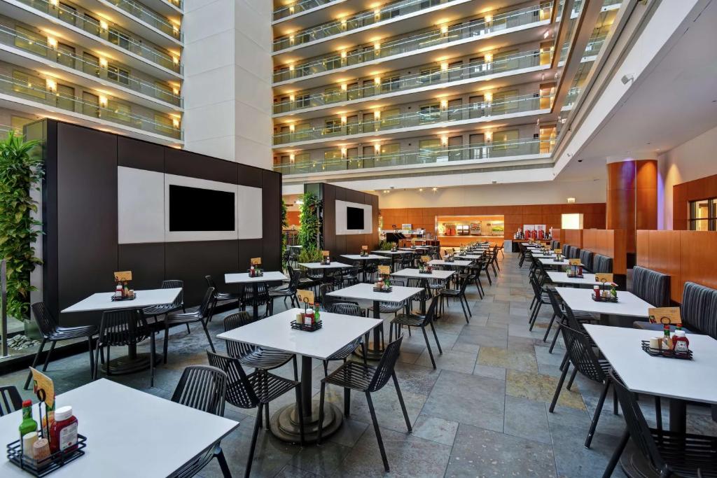 a restaurant with tables and chairs and a large building at Embassy Suites by Hilton Chicago Downtown Magnificent Mile in Chicago