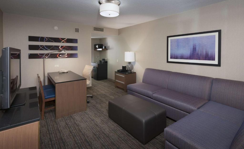 a living room with a couch and a desk at Embassy Suites by Hilton Chicago Downtown Magnificent Mile in Chicago