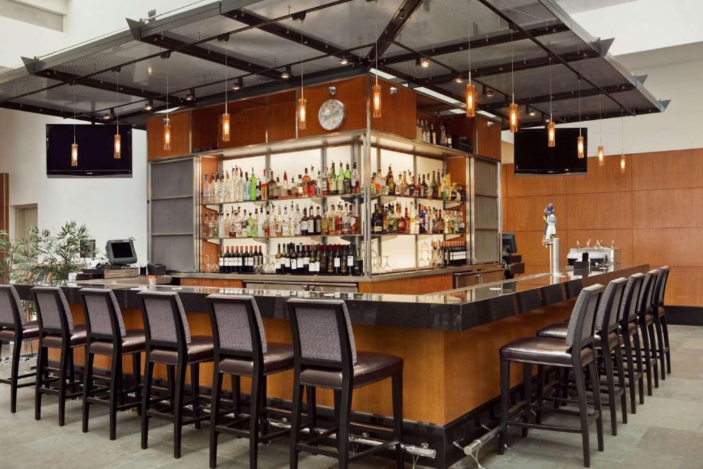 a bar with a bunch of bar stools at Embassy Suites by Hilton Chicago Downtown Magnificent Mile in Chicago
