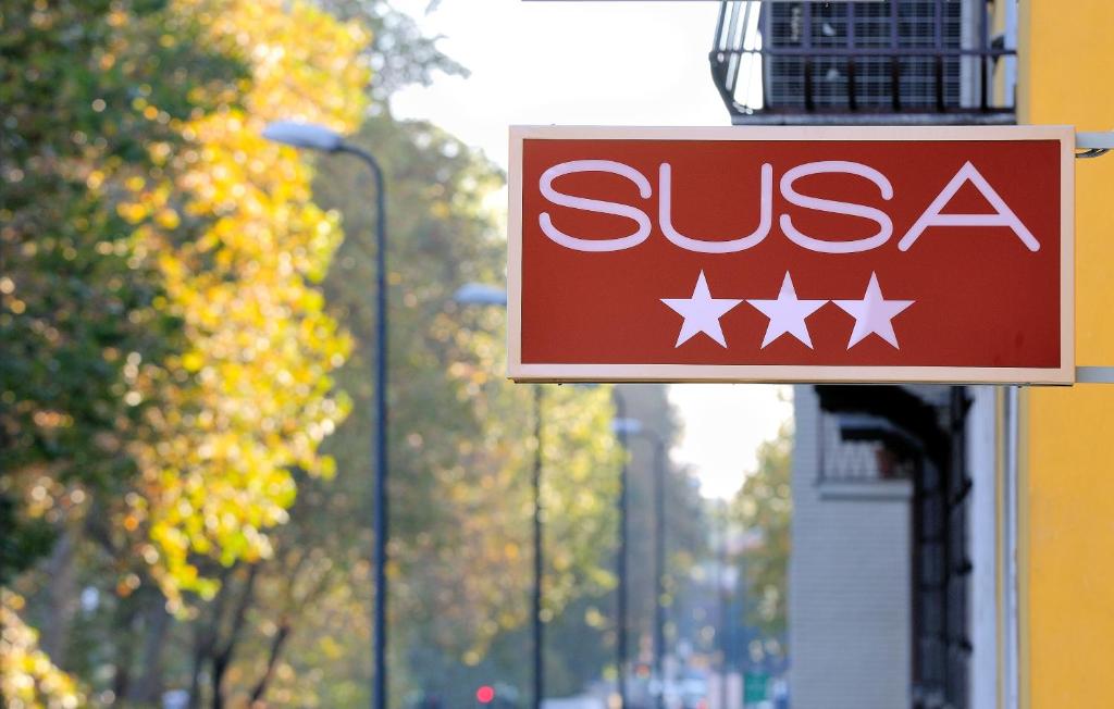 a sign for a sissa store on a street at Hotel Susa in Milan