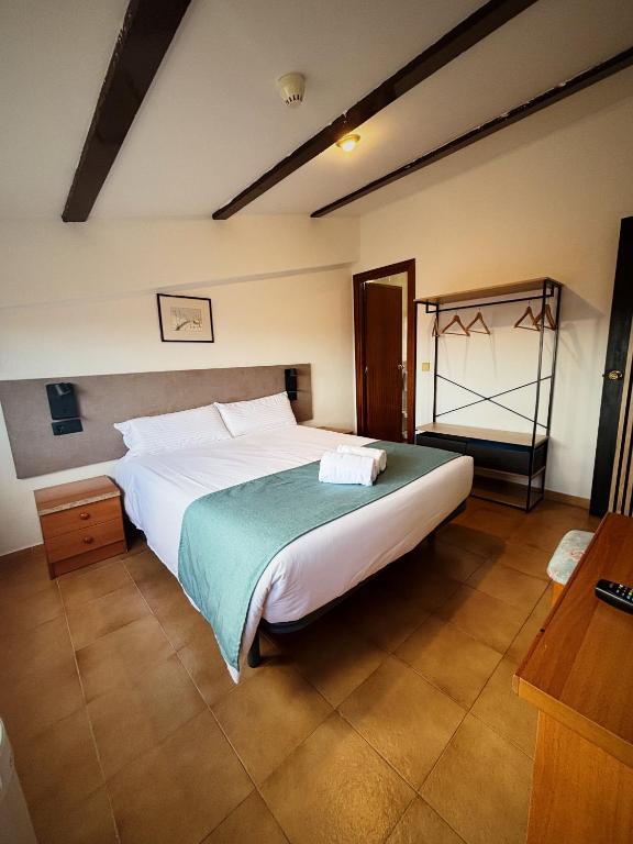 Postel nebo postele na pokoji v ubytování Hostal Legaz