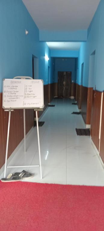 a room with a whiteboard in the middle of a room at Tabish INN in Trivandrum