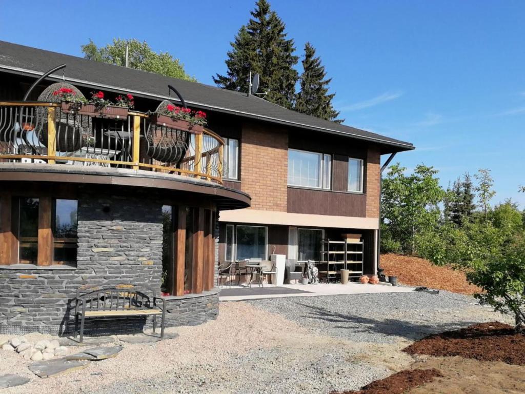a building with a balcony with flowers on it at Holiday Home Villa meka by Interhome in Sastamala