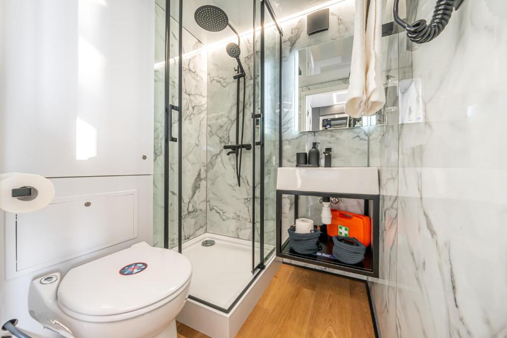 a bathroom with a toilet and a shower at The Homeboat Company Albufeira in Albufeira