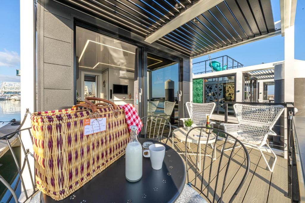 a patio with a table and chairs on a balcony at The Homeboat Company Albufeira in Albufeira