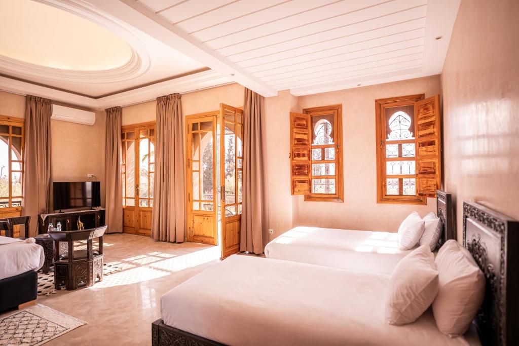 Postel nebo postele na pokoji v ubytování Palais Menzah & SPA