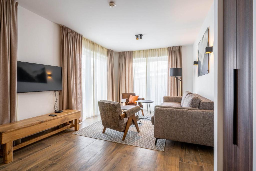 TV a/nebo společenská místnost v ubytování Alpenzauber Apartments by Monteviva