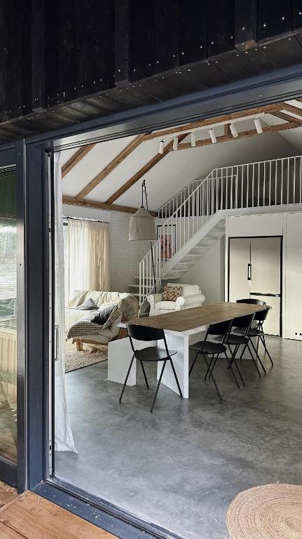 a dining room with a table and a bed at Wolny Las in Ławki