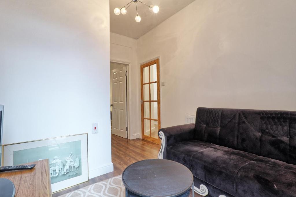 a living room with a couch and a fireplace at Ivy on Sea Villa in Southend-on-Sea