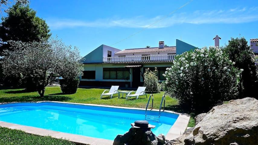 a house with a swimming pool in front of a house at Casa do Vale-Villa with private pool and garden in Palmela