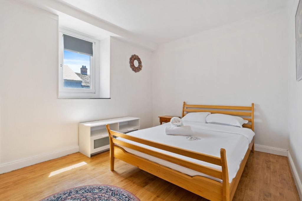 a bedroom with a bed and a window at Cozy 3BR Townhome Walk to City Center & Park Free in Luxembourg