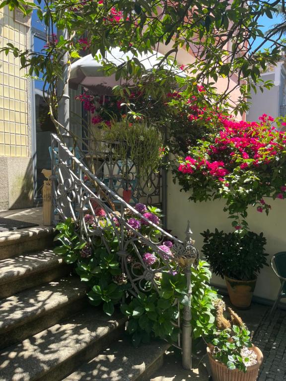 a bunch of flowers on the stairs of a house at Vila Camélia in Porto