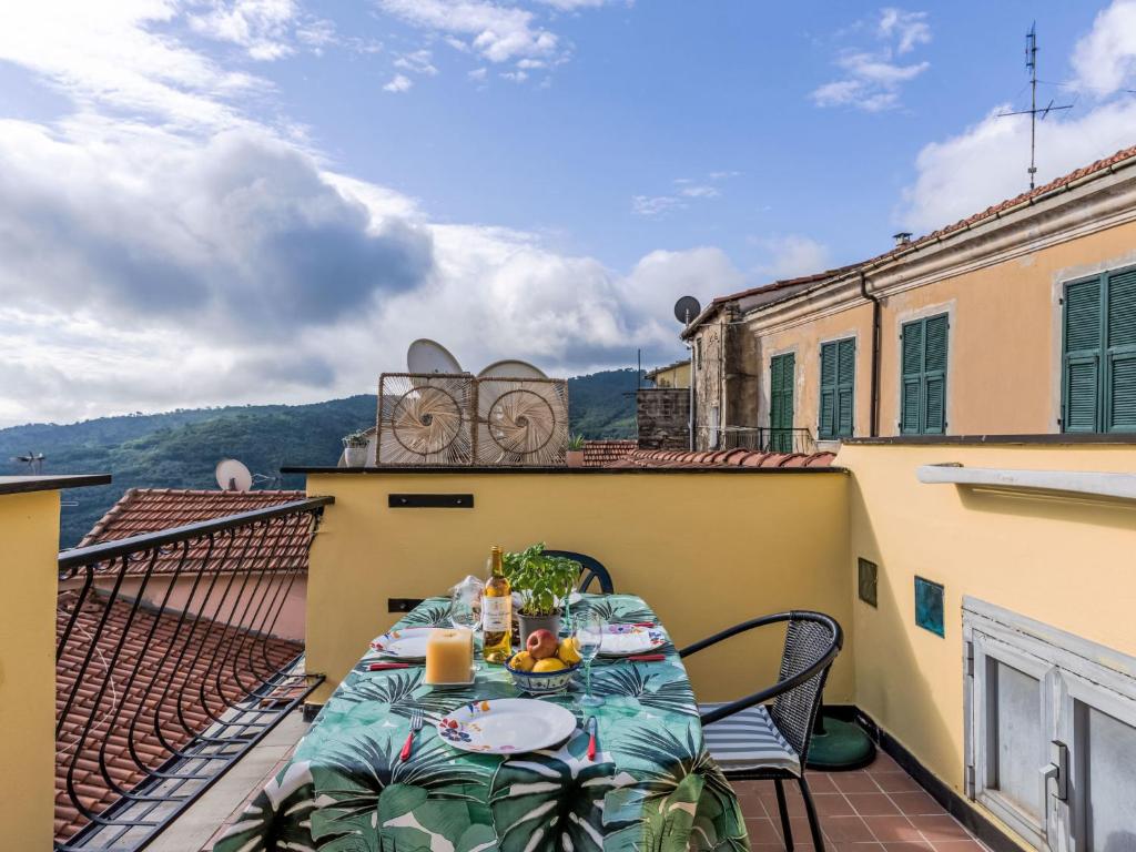 a table on the balcony of a building at Holiday Home Casa Alfonso e Derna by Interhome in Pietrabuona