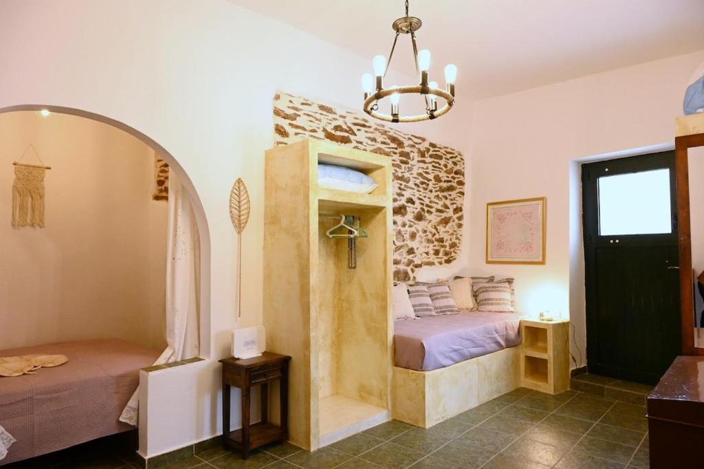 a bedroom with a bed in a room with a window at House on the island in Kithnos
