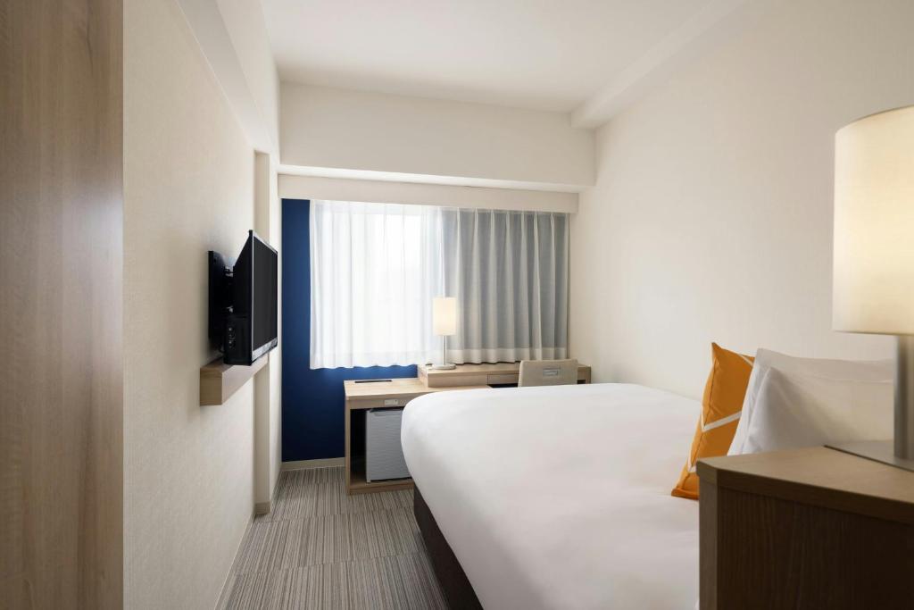 Postel nebo postele na pokoji v ubytování Four Points Flex by Sheraton Osaka Kitahama