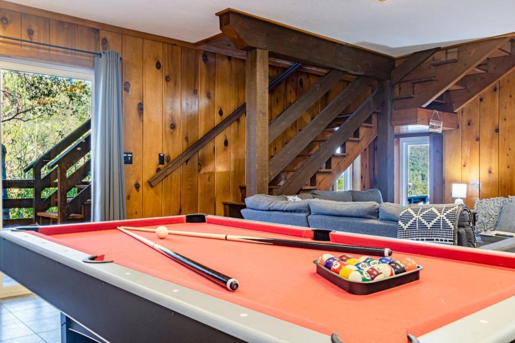 a pool table in a living room with wooden walls at Sierra Vista Lookout Lodge for 8 people with Hot tub, deck and trail to waterfalls in North Fork