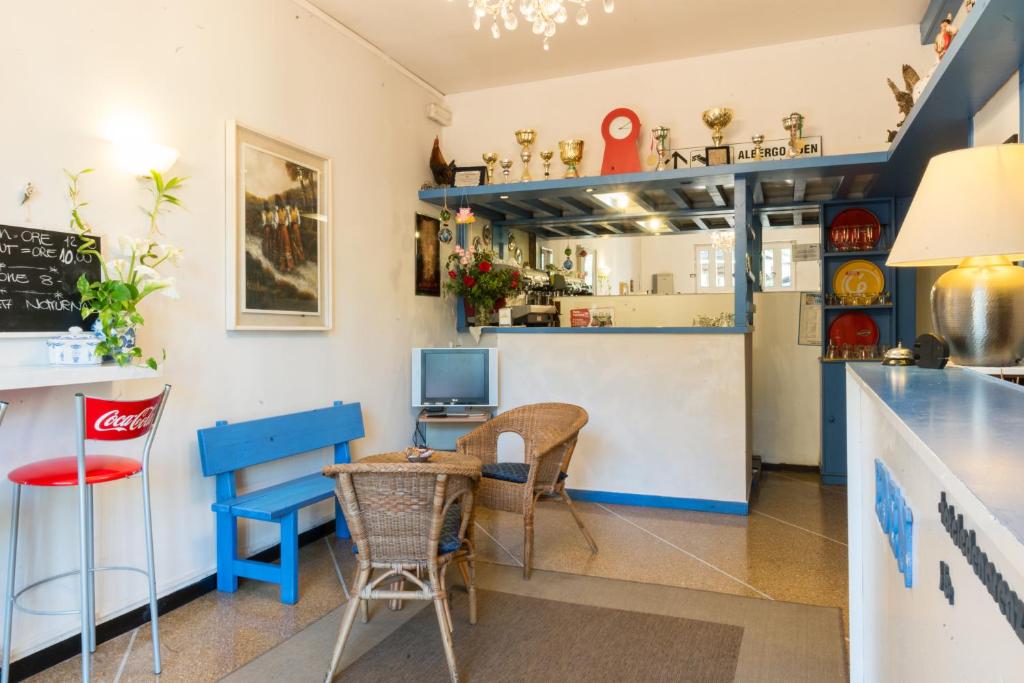 a restaurant with a counter and a table and chairs at Hotel Eden in Arenzano