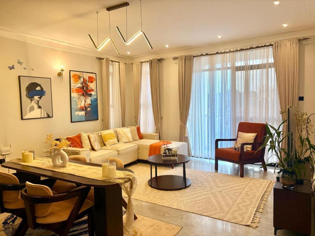 a living room with a couch and a table at Alphaton homez in Kampala