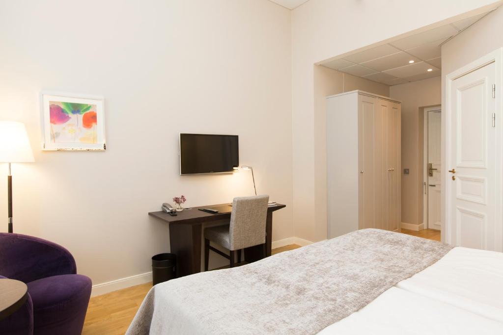 Postel nebo postele na pokoji v ubytování Elite Hotel Adlon