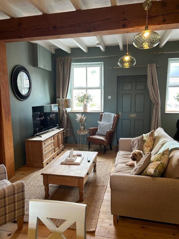 a living room with a couch and a coffee table at Copley Cottage in Copley