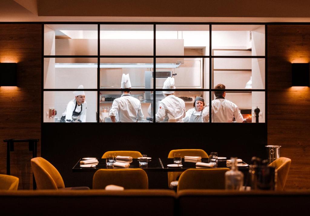 a group of chefs in the kitchen in a restaurant at Valtur Cervinia Cristallo Ski Resort in Breuil-Cervinia