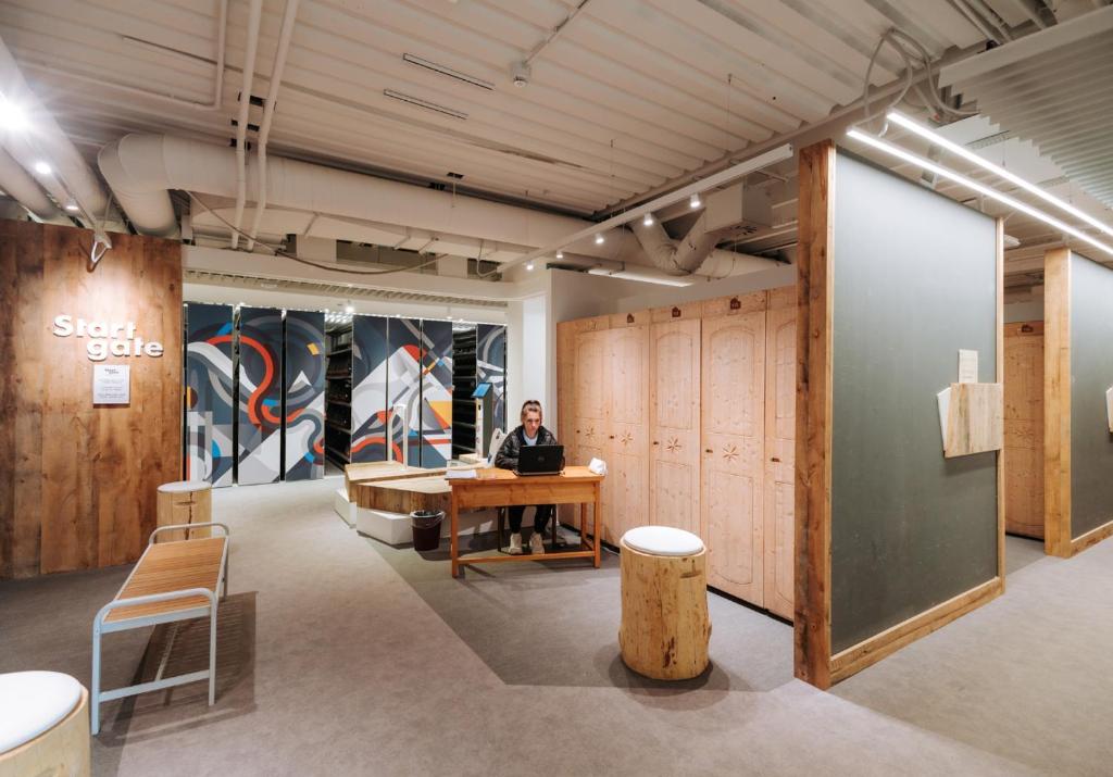 a man sitting at a desk in an office with a laptop at Valtur Cervinia Cristallo Ski Resort in Breuil-Cervinia