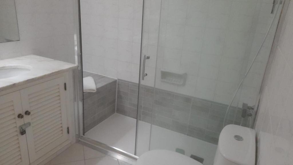 a bathroom with a shower with a toilet and a sink at Albufeira - Casa Balaia Resort in Albufeira