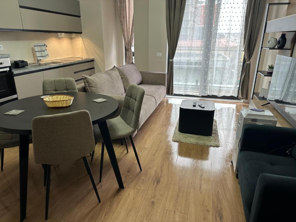 a living room with a table and a couch at SISI Apartment in Tirana