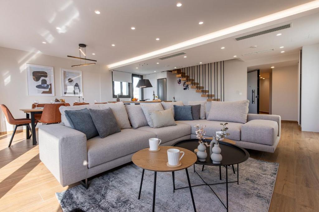 a living room with a couch and a table at Riviera Escape Penthouse Suites in Athens