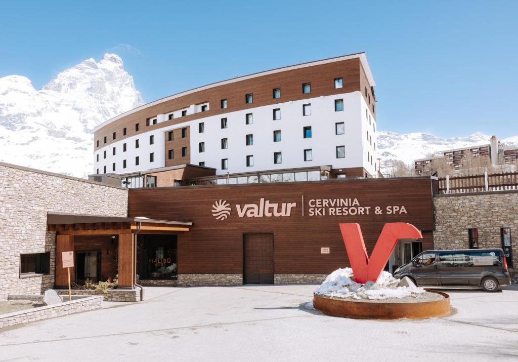a hotel with a sign in front of a building at Valtur Cervinia Cristallo Ski Resort in Breuil-Cervinia