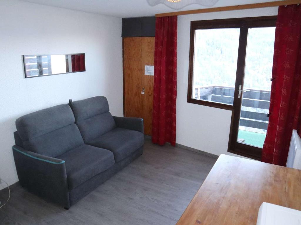 un salon avec un canapé et une fenêtre dans l'établissement Studio aux Orres - Ski aux pieds, Animaux acceptés - FR-1-322-21, aux Orres
