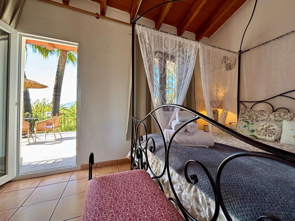 a bedroom with a wrought iron bed and a patio at Hotel Altea Paradise 1917 - Adults Only in Altea