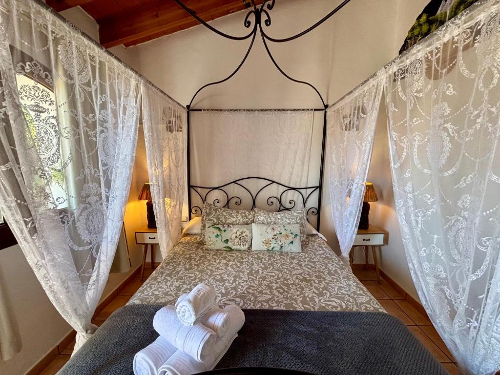 a bedroom with a canopy bed with white curtains at Hotel Altea Paradise 1917 - Adults Only in Altea
